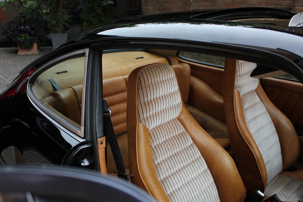 Open car door showing tan leather seats