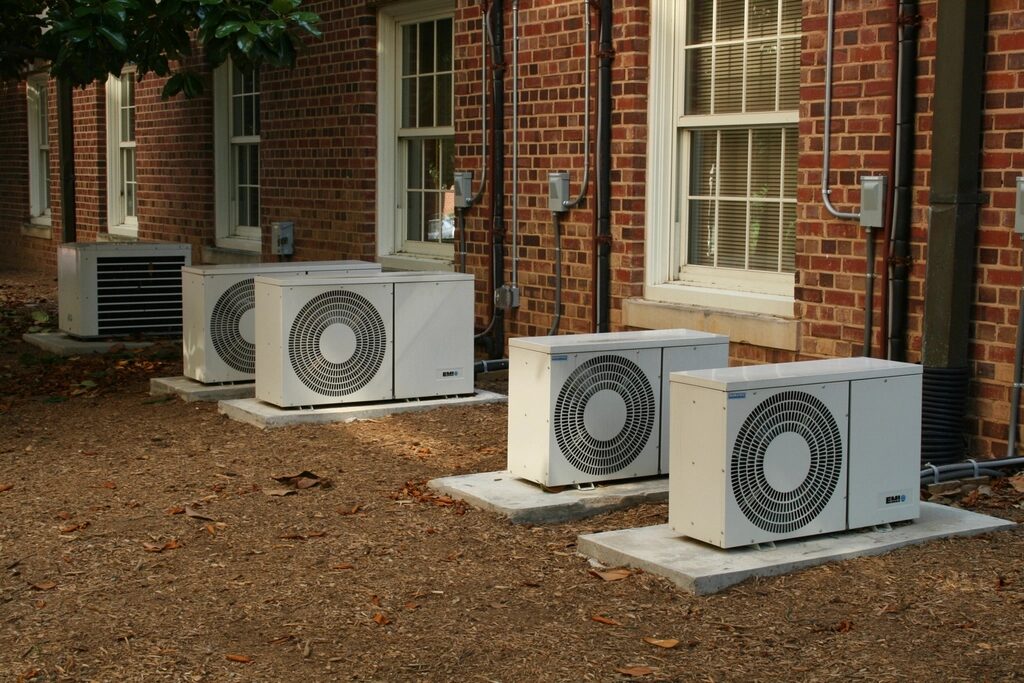 Outdoor air-conditioning condensers beside a brick building