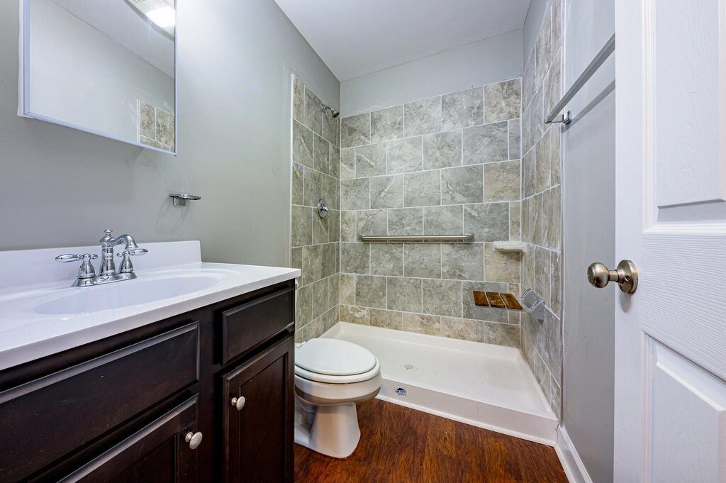 Bathroom with a tiled shower, bath and basin