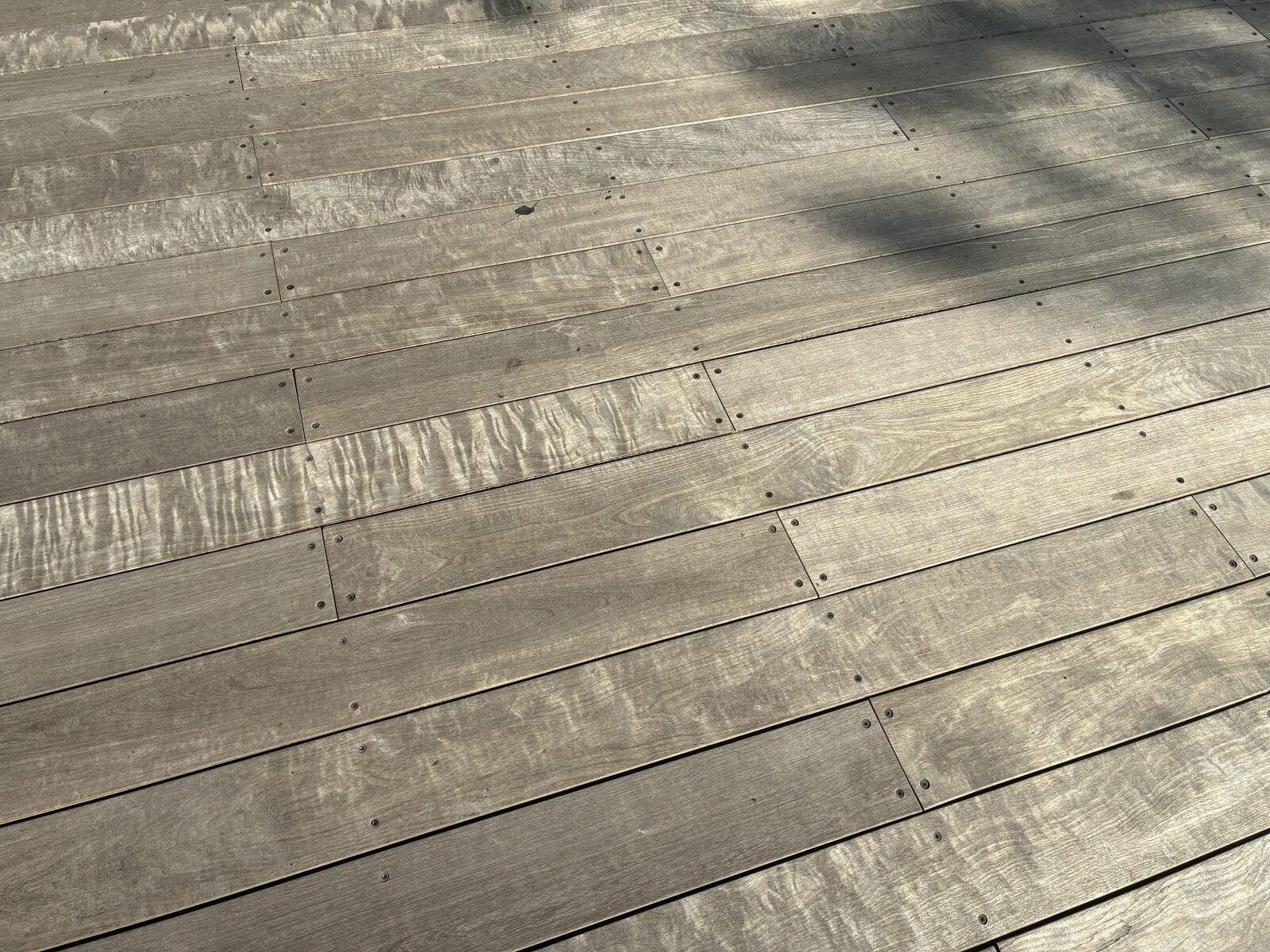 Grey, weathered wood deck boards before washing