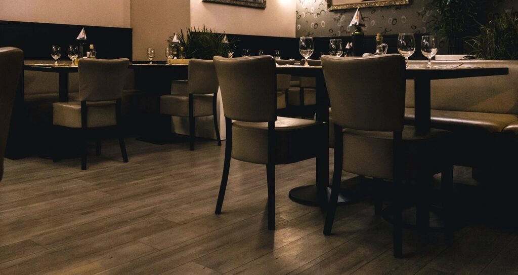 Tables set in a dim dining room