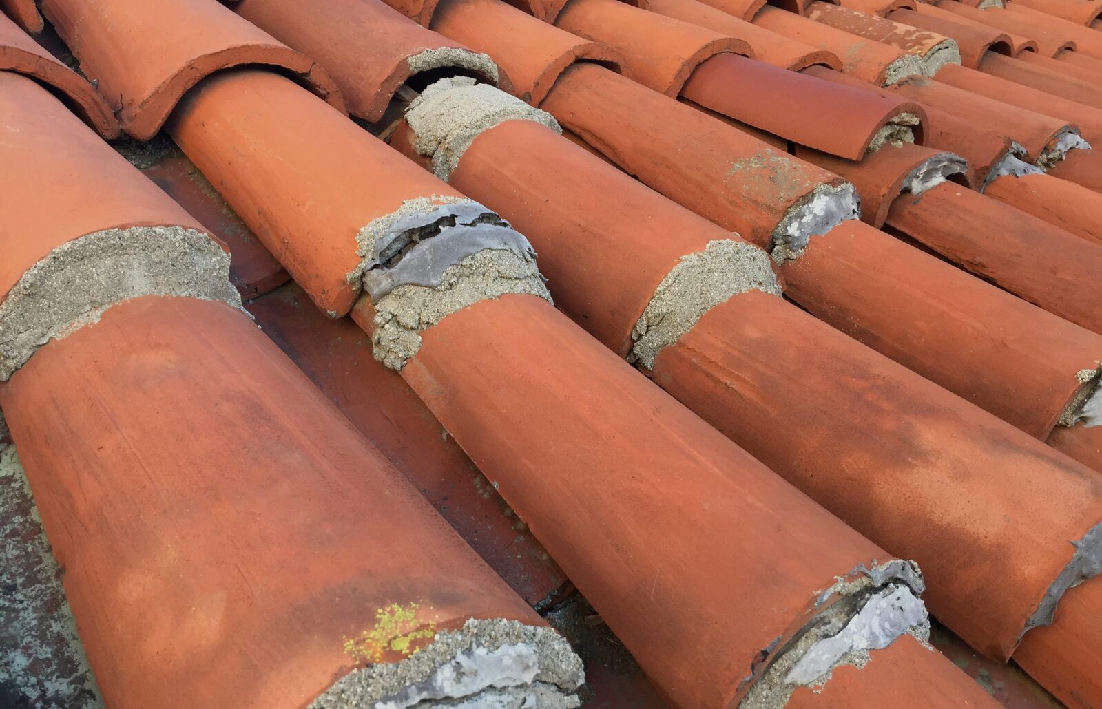 Close view of overlapping terracotta roof tiles