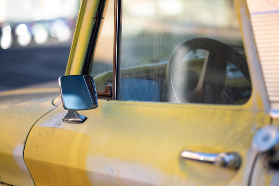 Yellow truck door with its side window and mirror
